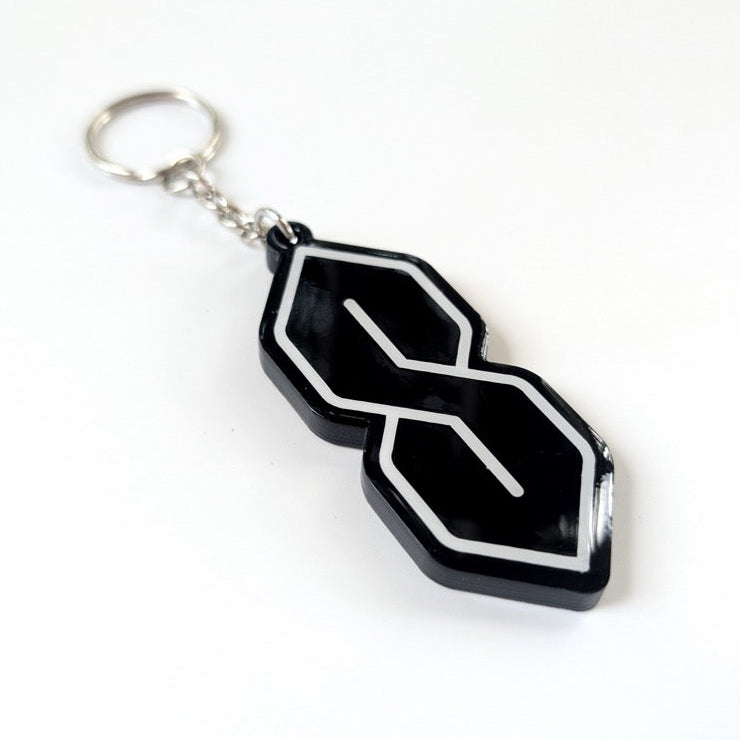 Black and white geometric keychain on a white background